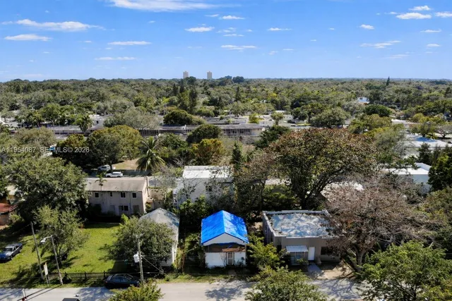 an aerial view of a house with a yard and outdoor seating
