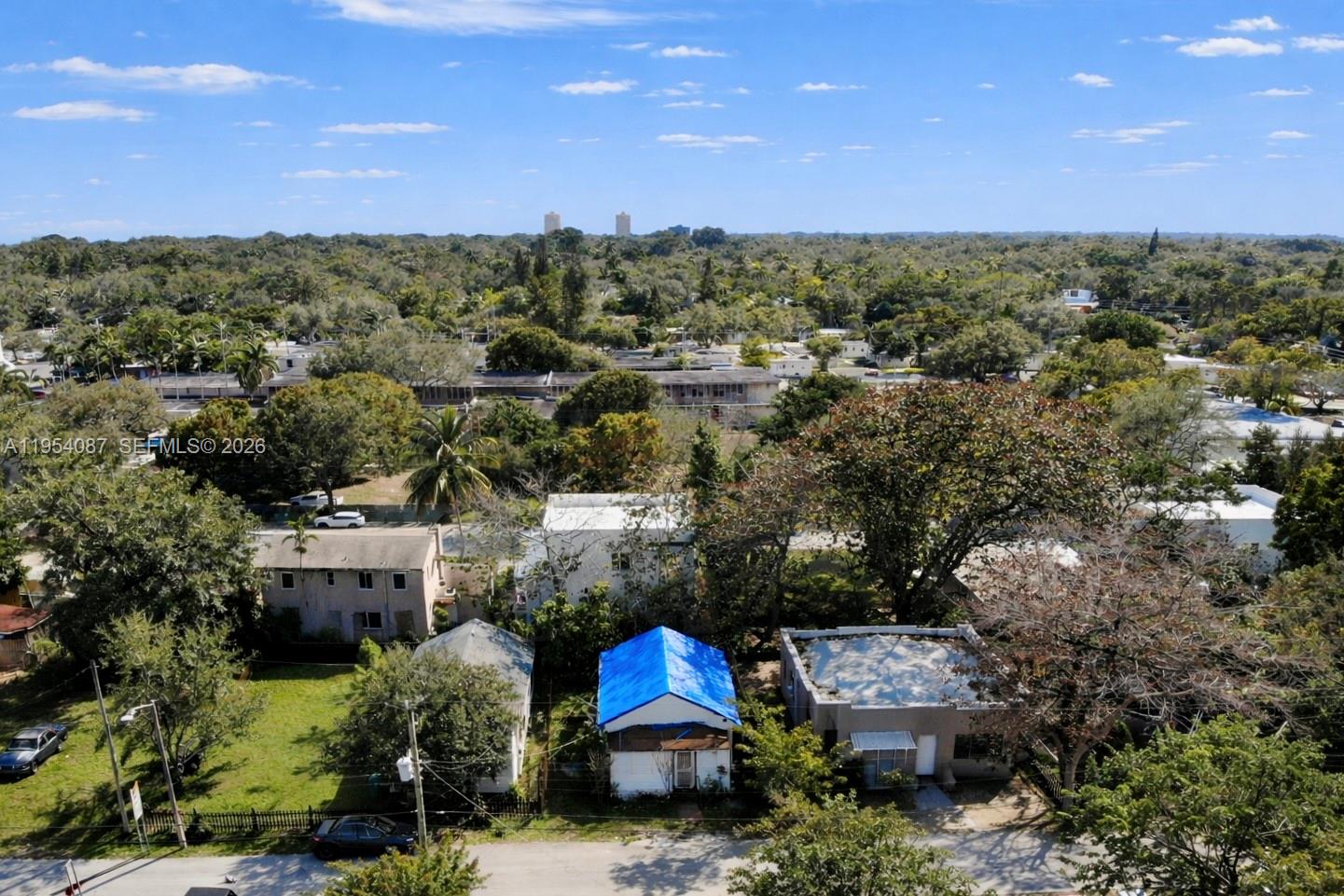 3748 Washington Avenue Miami, FL 33133 - Photo 1 of 15 an aerial view of a house with a yard and outdoor seating