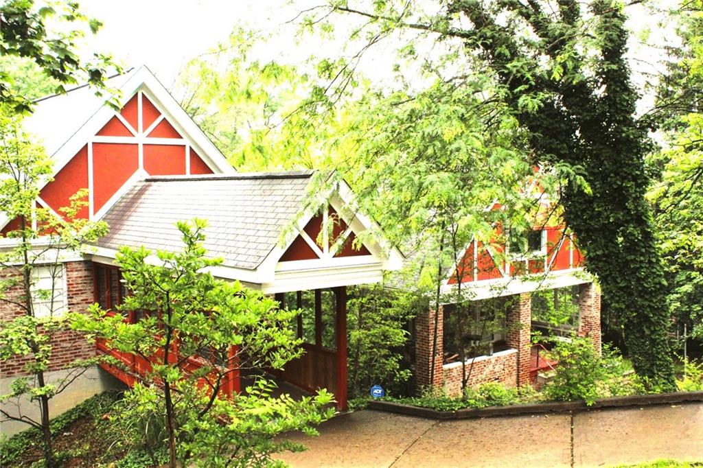 a view of house with a yard and sitting area