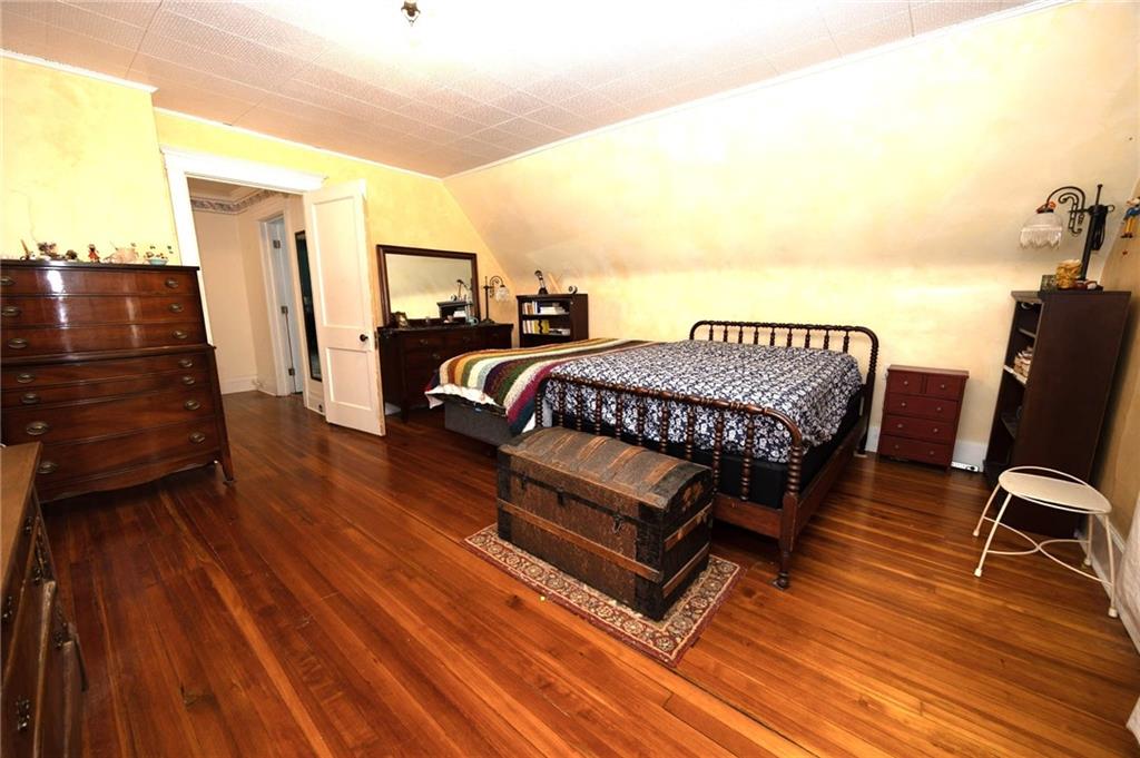 200 School Street Pittsburgh, PA 15205 - Photo 33 of 46 a bedroom with a bed and wooden floor