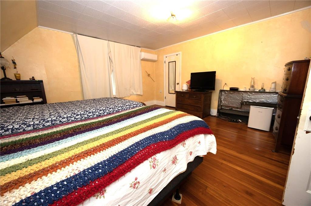 200 School Street Pittsburgh, PA 15205 - Photo 34 of 46 a bedroom with a bed and wooden floor