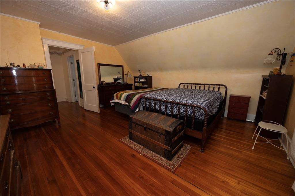 200 School Street Pittsburgh, PA 15205 - Photo 37 of 46 a bedroom with a bed a chair and wooden floor