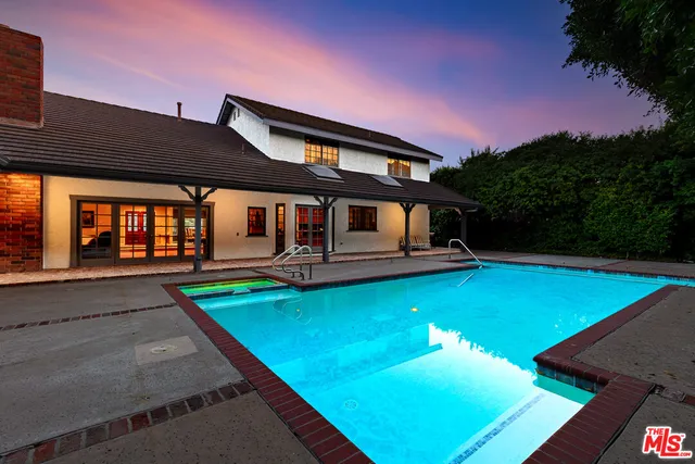 a view of swimming pool with lounge chair and fire pit