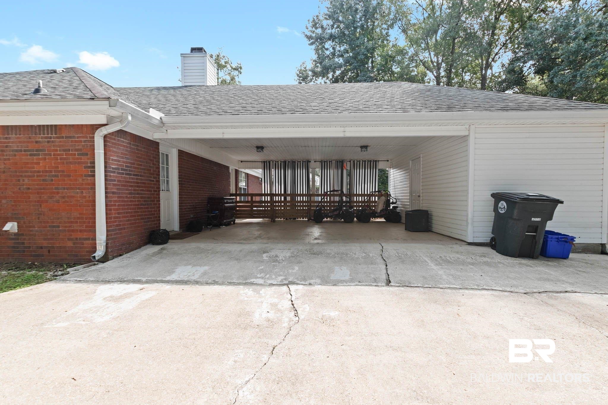 20685 Lowry Drive Fairhope, AL 36532 - Photo 47 of 48 View of car parking with concrete driveway and an attached carport