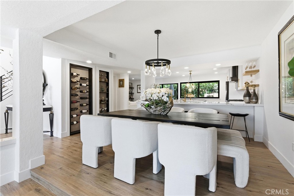 23281 Atlantis Way Dana Point, CA 92629 - Photo 13 of 81 a kitchen with stainless steel appliances kitchen island granite countertop a table and chairs in it