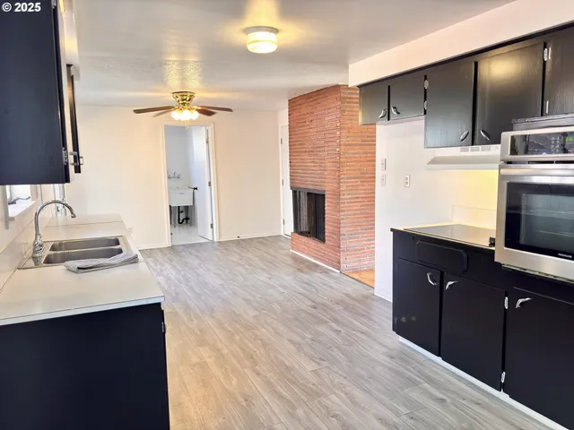a kitchen with a sink appliances and cabinets