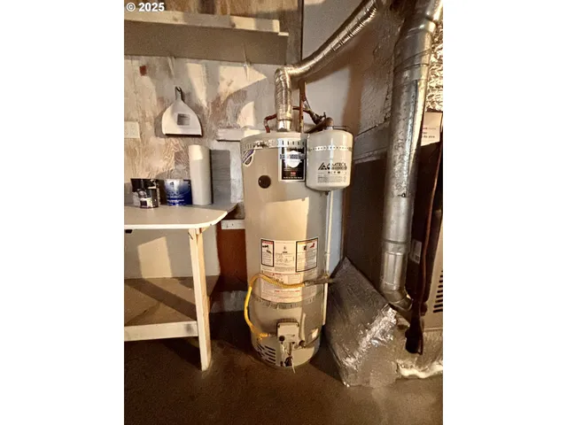 a room with water heater and white walls