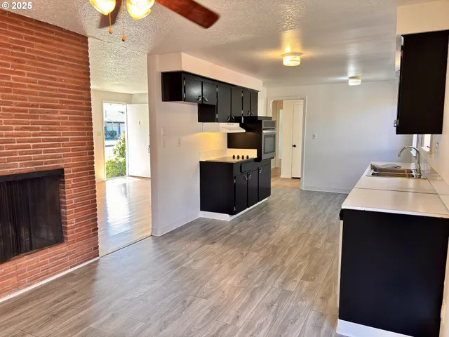 a kitchen with kitchen island a sink stainless steel appliances and cabinets