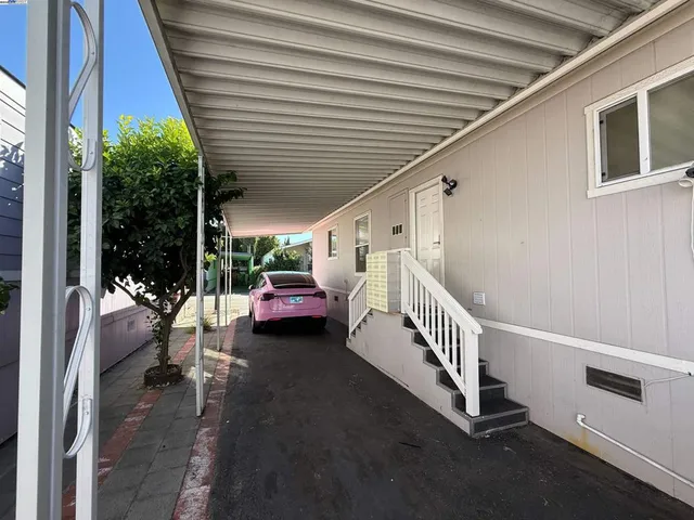 a view of a porch with furniture and a yard