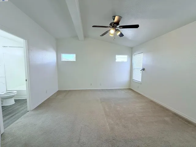a view of a livingroom with a ceiling fan and window