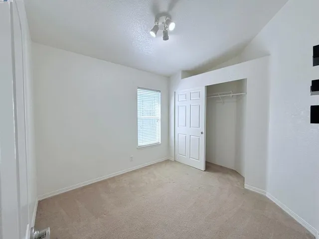 an empty room with a empty space and windows