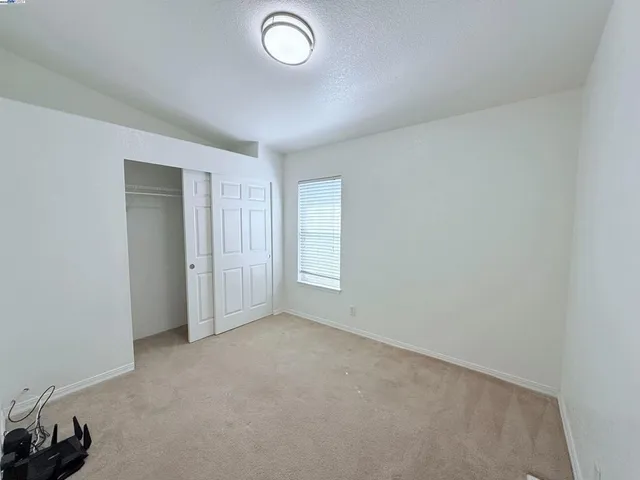 a view of an empty room and a window