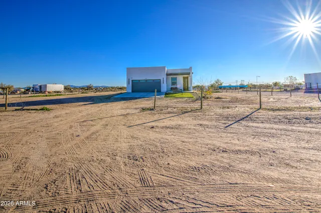 a house view with swimming pool in front of it