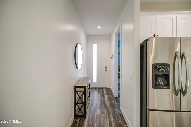 a kitchen with stainless steel appliances granite countertop a sink and a refrigerator