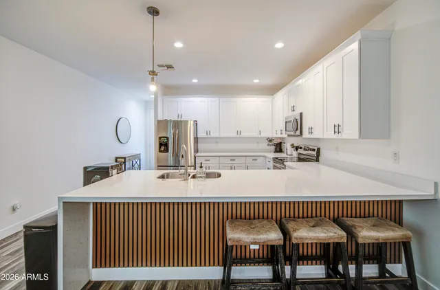a kitchen with refrigerator cabinets and wooden floor