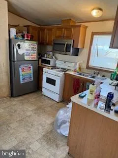 a kitchen with stainless steel appliances granite countertop a refrigerator and a stove