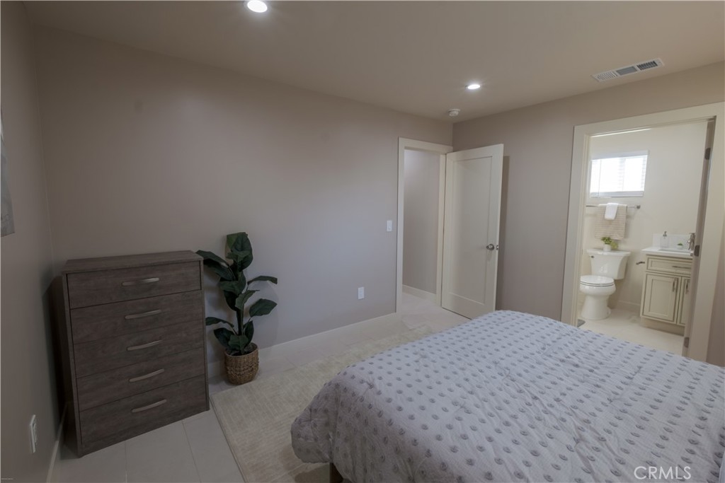 223 South Aprilia Avenue Compton, CA 90220 - Photo 42 of 46 a bedroom with a bed and a bathroom