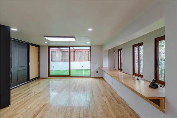 a view of a room with wooden floor