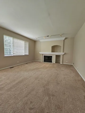 an empty room with a empty space and windows