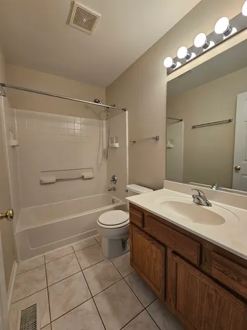 an empty room with a ceiling fan and window