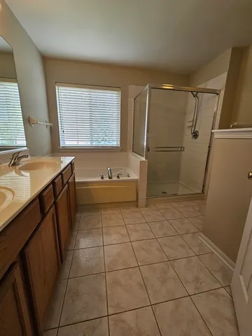 a bathroom with a granite countertop sink mirror vanity and toilet