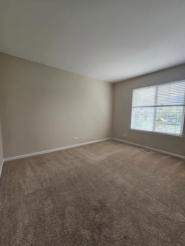 an empty room with a empty space and windows