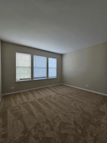 a bathroom with a toilet and a mirror