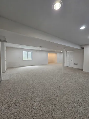 a view of a park with trees and flowers in the background