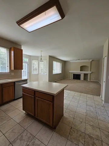 a kitchen with a stove top oven and cabinets
