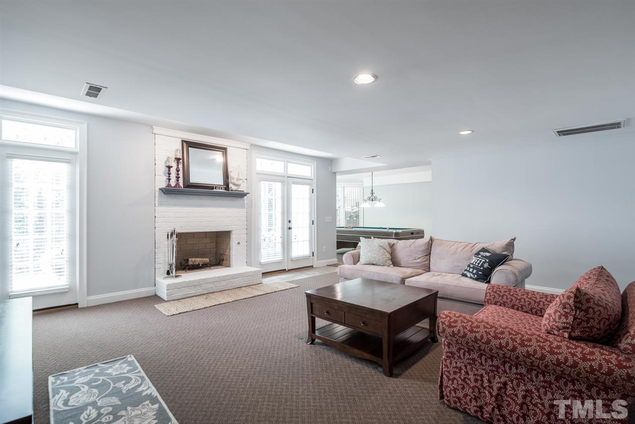 4407 White Chapel Way Raleigh, NC 27615 - Photo 20 of 25 Basement living room with fireplace and separate entrance