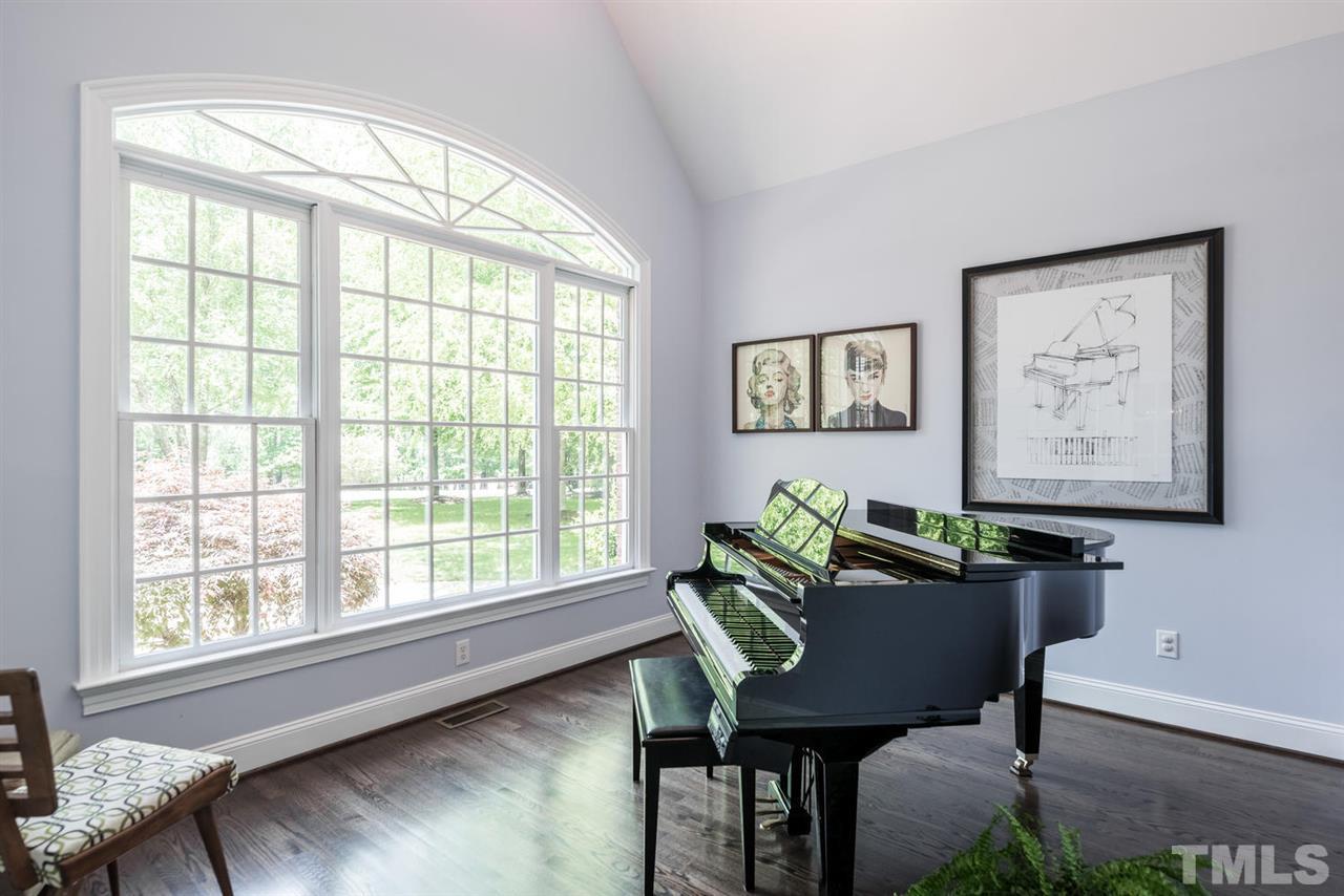 4407 White Chapel Way Raleigh, NC 27615 - Photo 4 of 25 Warm and inviting living room or in this case, music room with vaulted ceiling
