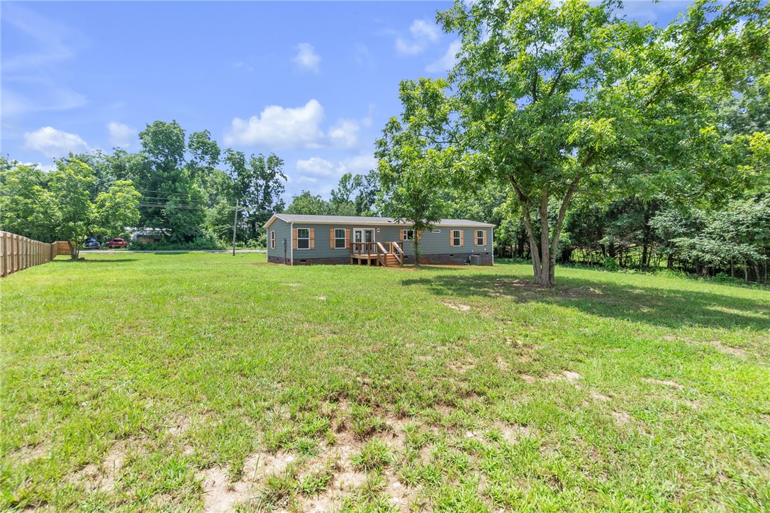 108 Old River Road Iva, SC 29655 - Photo 25 of 31 A modest residence is nestled on a verdant, expansive lot, offering ample outdoor space and natural serenity.