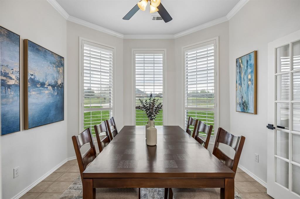 11090 Prairie Lakes Lane Forney, TX 75126 - Photo 14 of 40 a view of a dining room with furniture window and wooden floor