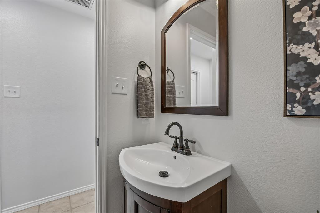 11090 Prairie Lakes Lane Forney, TX 75126 - Photo 20 of 40 a bathroom with a sink and a mirror