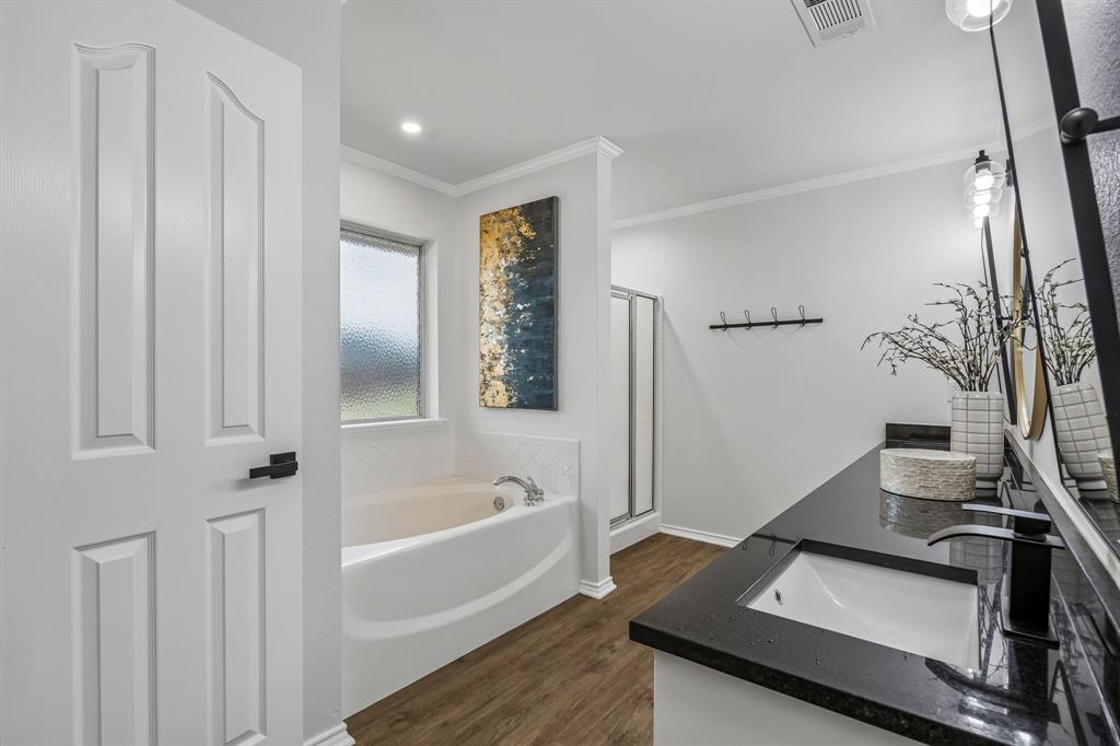 11090 Prairie Lakes Lane Forney, TX 75126 - Photo 28 of 40 a bathroom with a bathtub and a sink