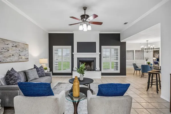 a living room with furniture a chandelier and a fireplace