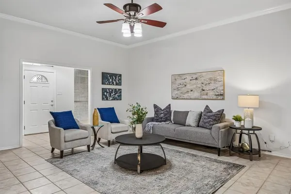 a living room with furniture and wooden floor
