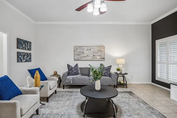 a living room with furniture and a potted plant