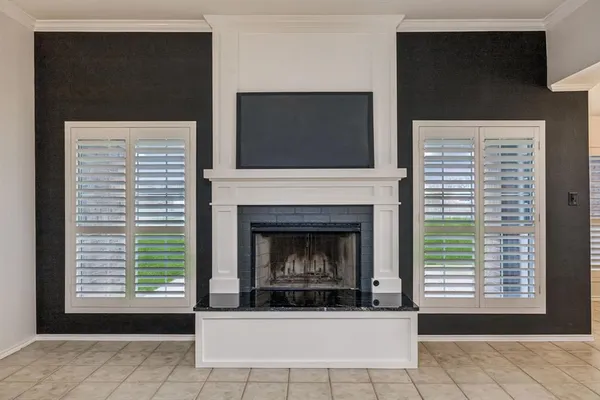 a living room with a fireplace and a flat screen tv