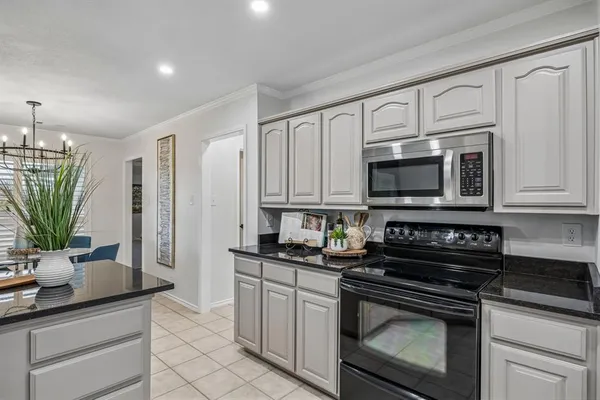 a kitchen with white cabinets stainless steel appliances and a sink