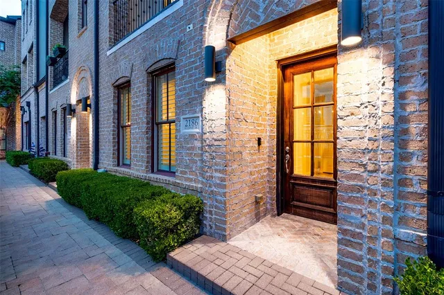 a view of a brick house with a large windows