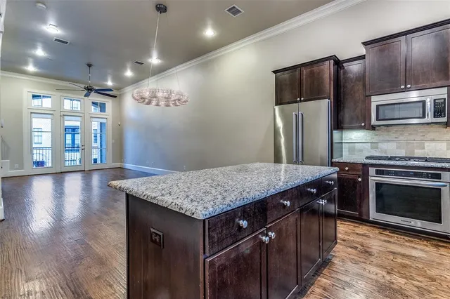 a view of an entryway with wooden floor and cabinet