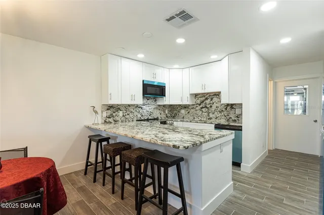 a kitchen with a table and chairs in it
