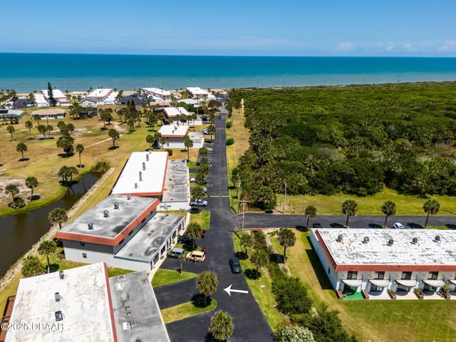 an aerial view of residential houses with outdoor space