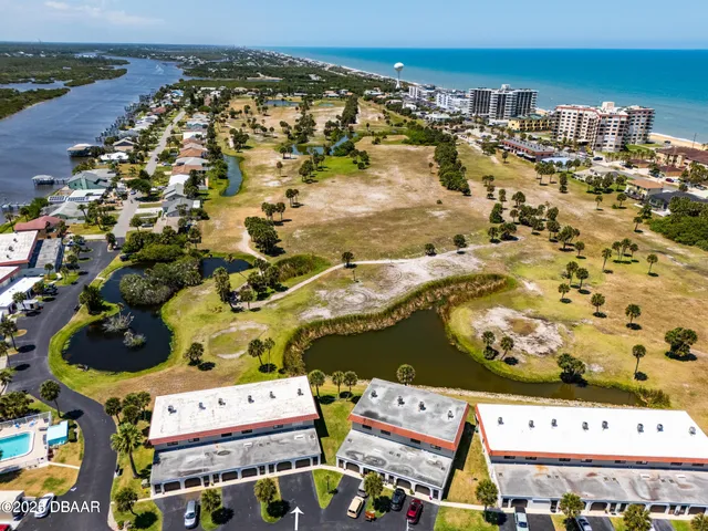 an aerial view of residential houses with outdoor space