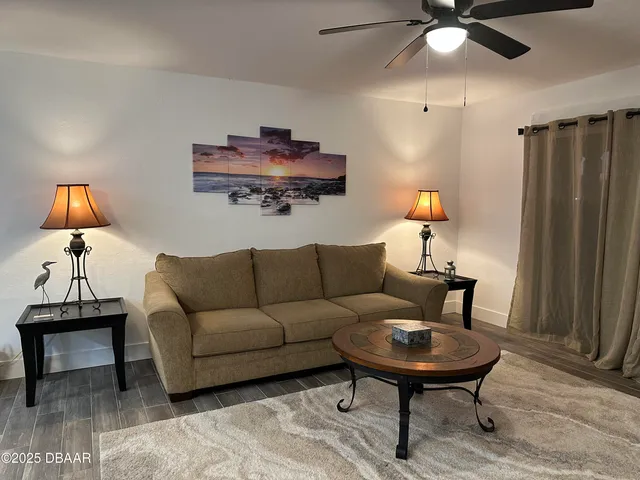 a living room with furniture and a lamp