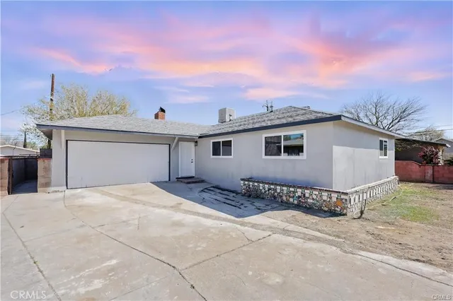 a view of a house with a wooden fence