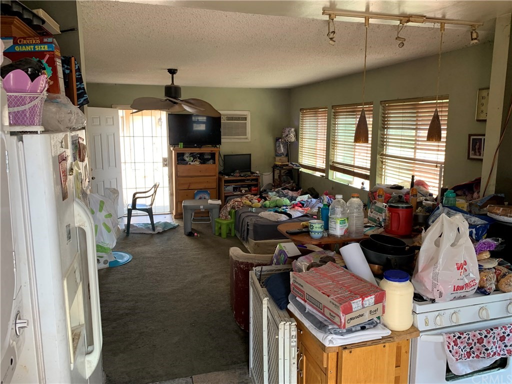 7771 Philbin Avenue Riverside, CA 92503 - Photo 15 of 30 a living room with furniture and a flat screen tv