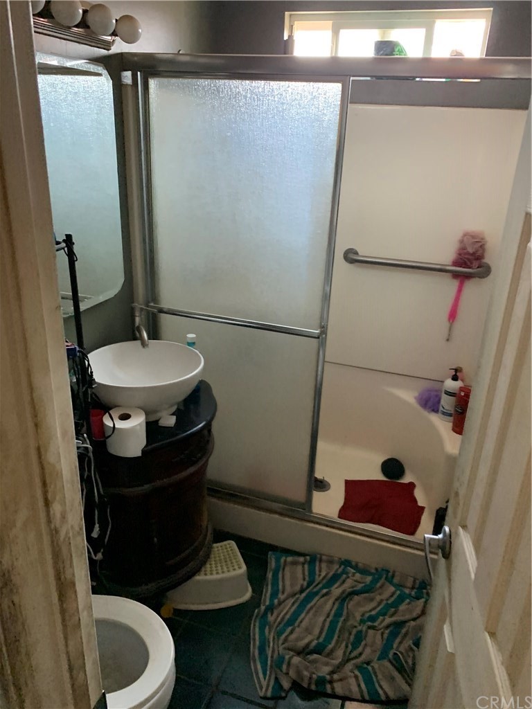 7771 Philbin Avenue Riverside, CA 92503 - Photo 17 of 30 a bathroom with a sink toilet and shower