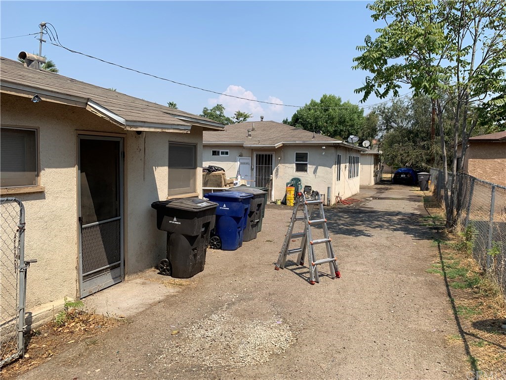 7771 Philbin Avenue Riverside, CA 92503 - Photo 2 of 30 a view of a patio with a table and chairs under an umbrella